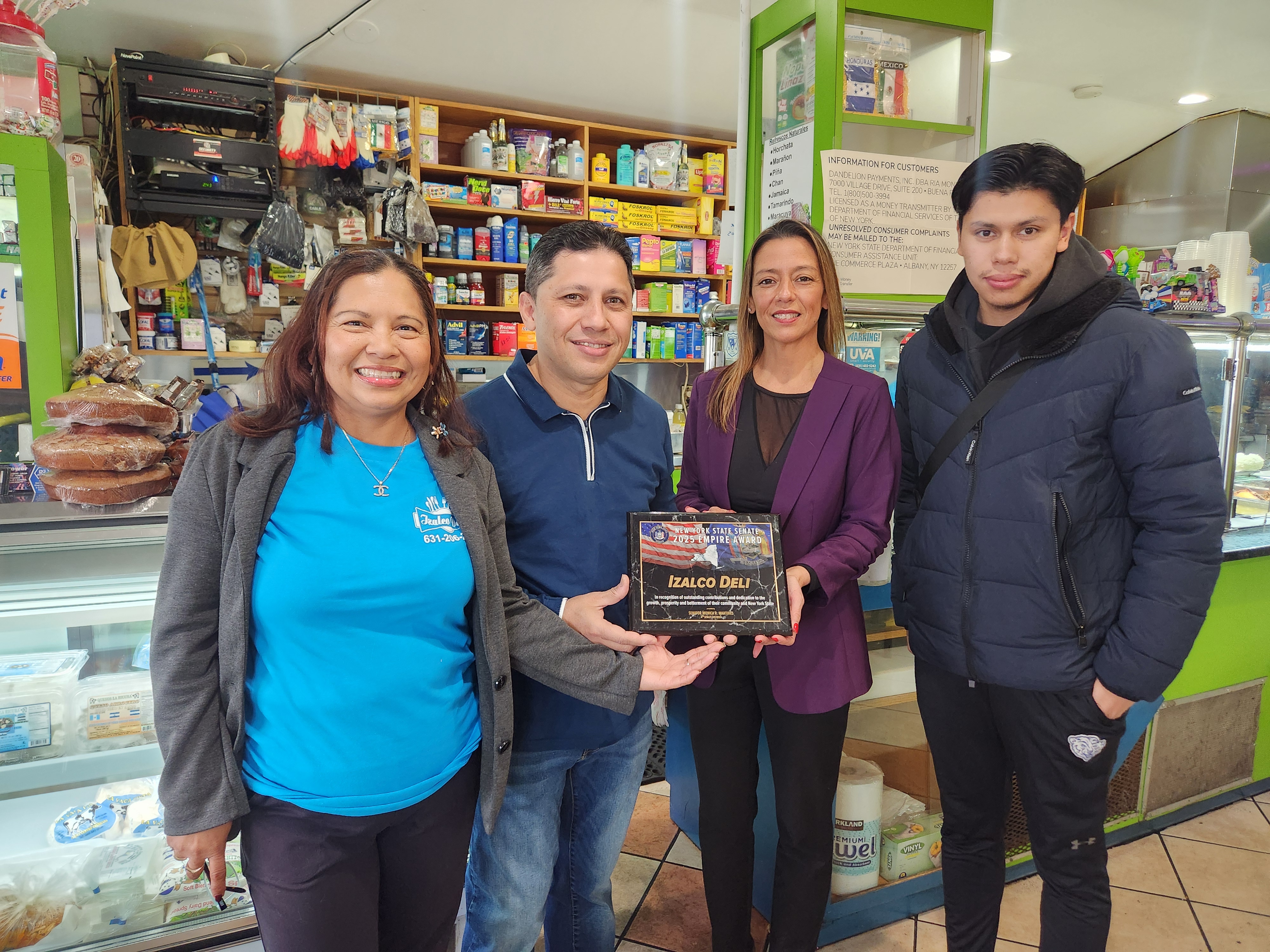 Photo: Wilber Gomez (center), owner of Izalco Deli, receives an Empire Award from State Sen. Monica R. Martinez.  