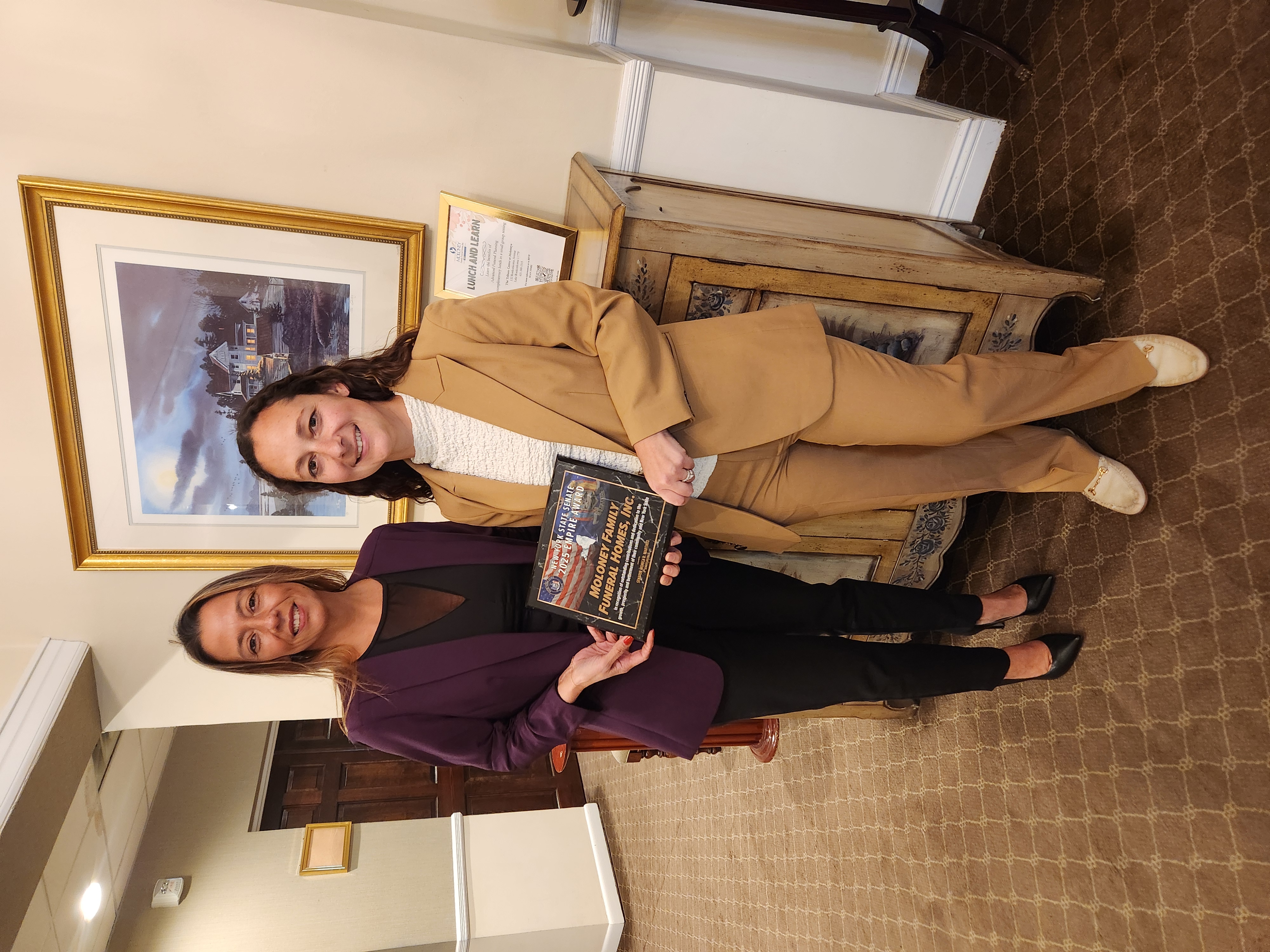 Photo (left to right): State Sen. Monica R. Martinez presents an Empire Award to Danielle Moloney of Moloney Family Funeral Homes.