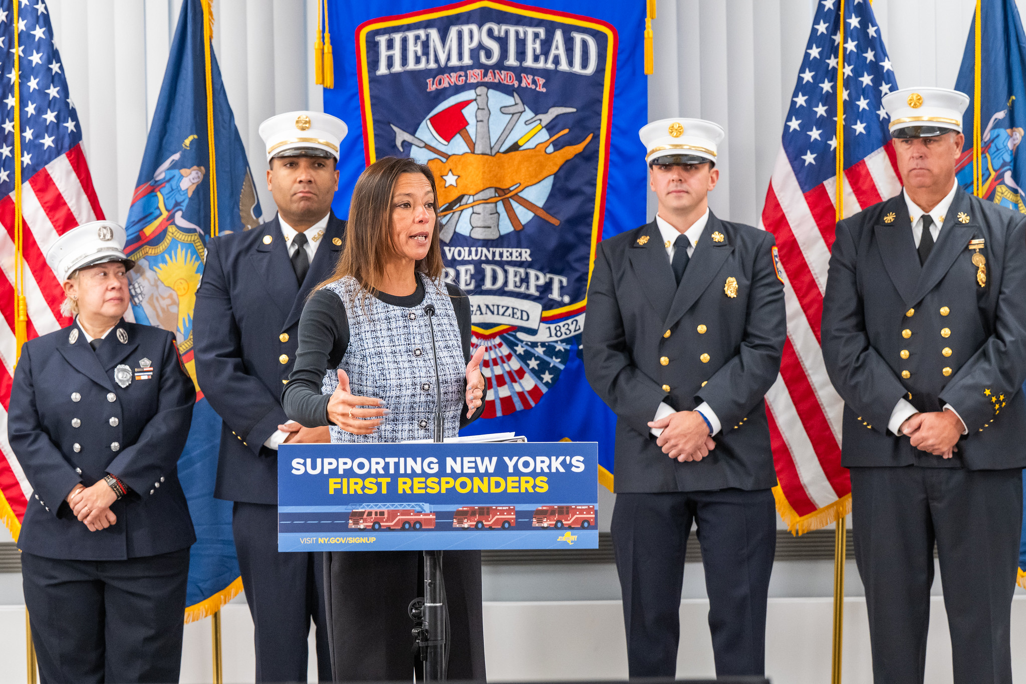 Photo image of NYS Senator Monica R. Martinez speaking prior to the bill signing of her legislation to increase the state income tax credit for volunteer firefighters and ambulance workers.