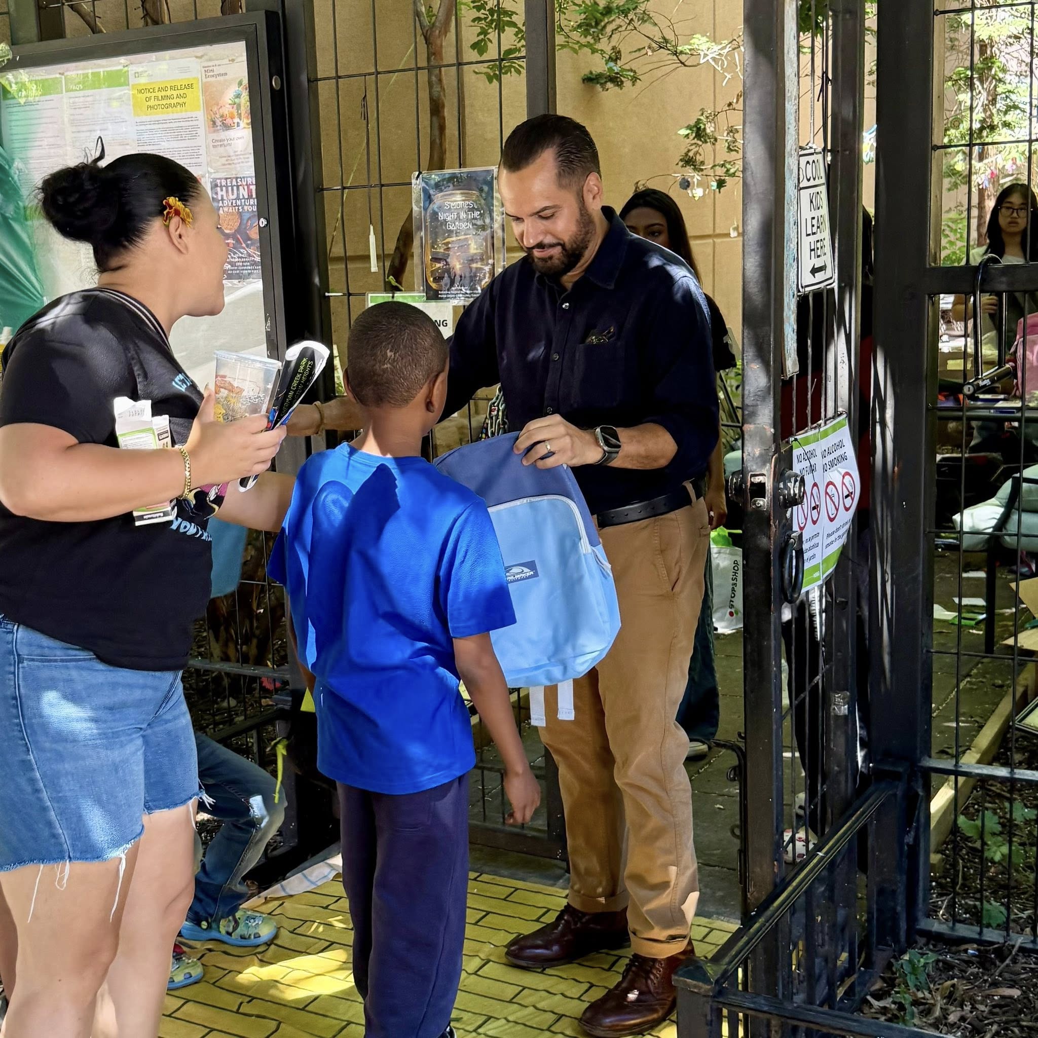 Senator Serrano handing out supplies at Home Depot Children’s Garden and Los Amigos Community Garden