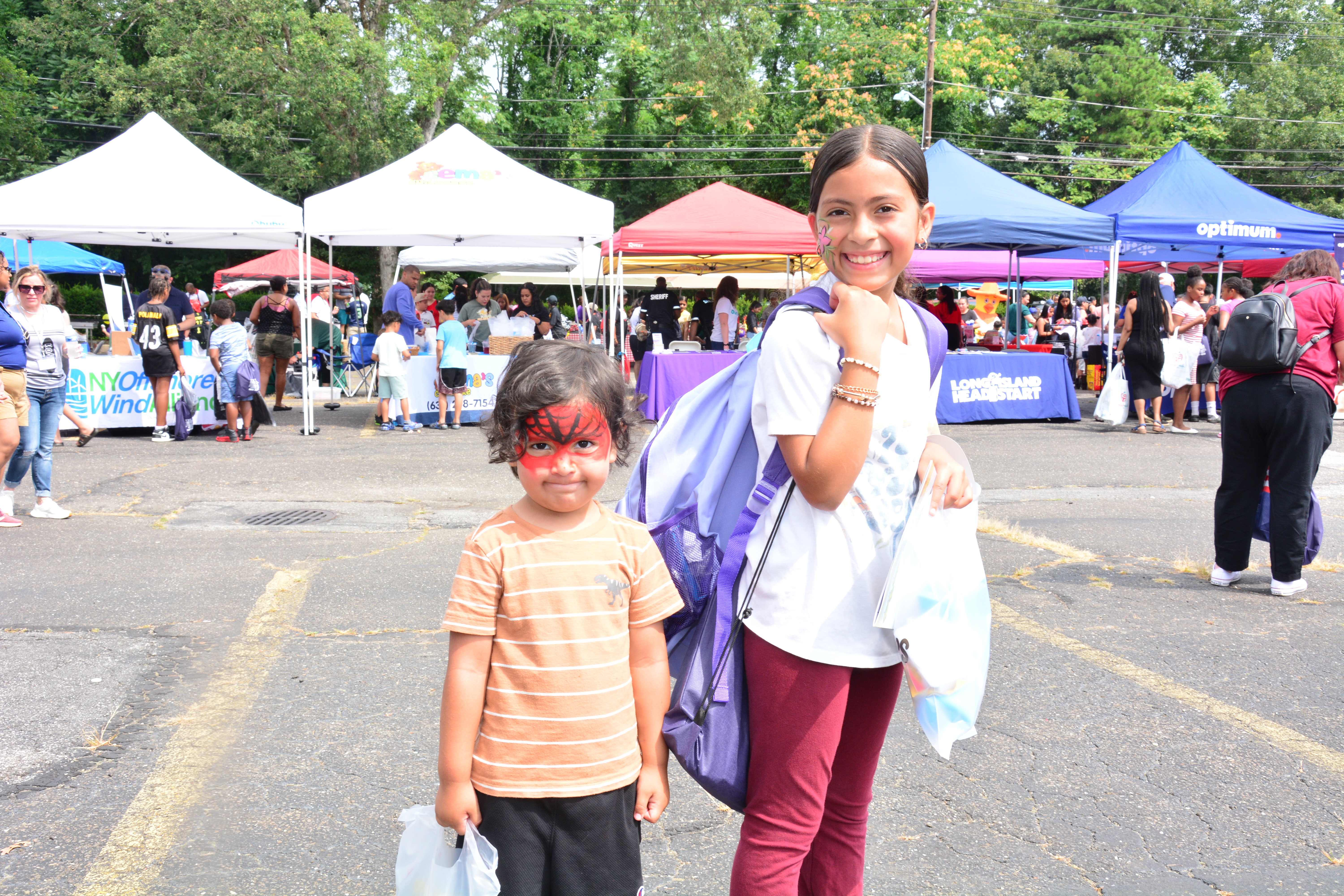 Photo of two students holding backpacks at the Brentwood backpack and school supply event on Saturday, Aug. 16, 2025.