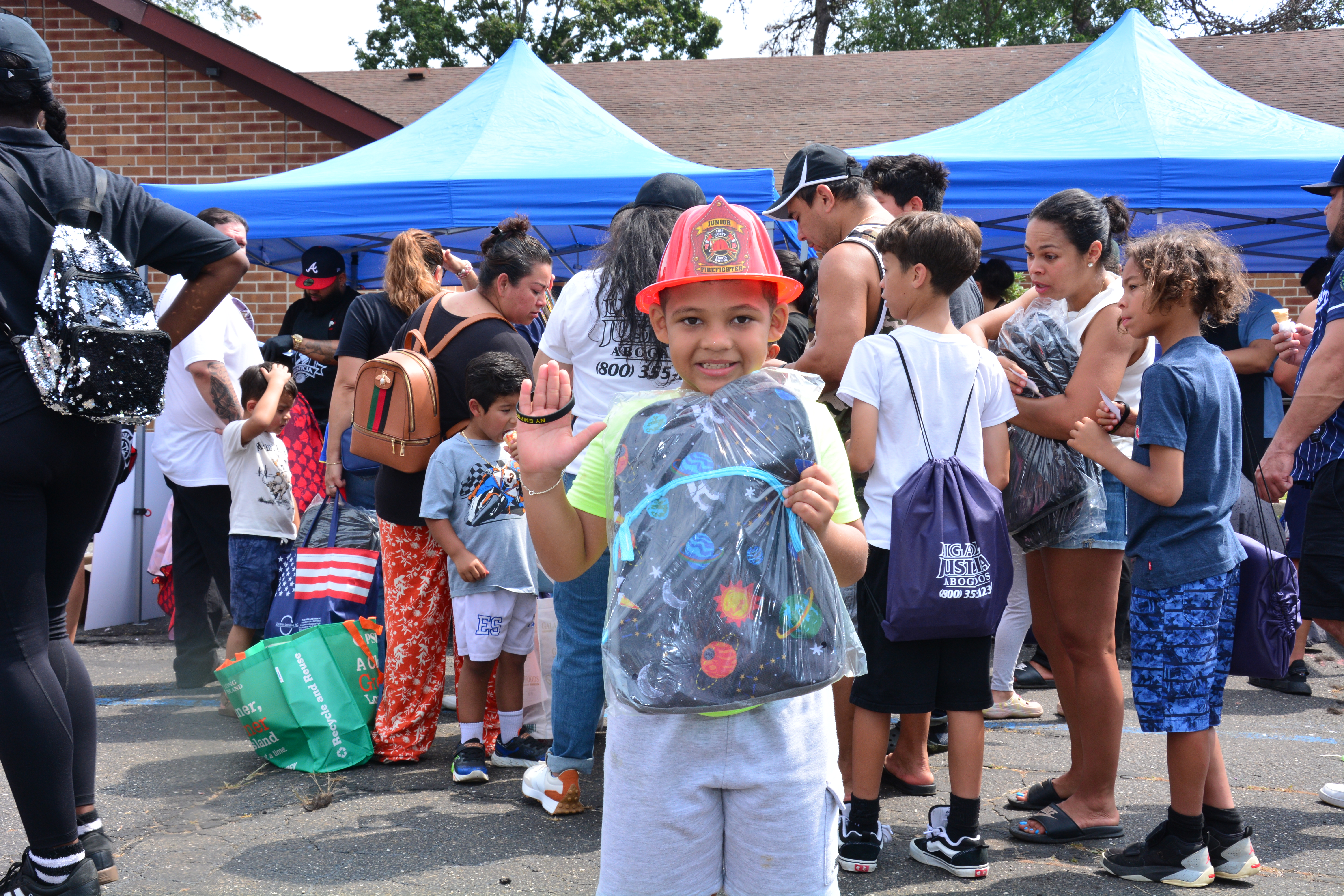 Photo of student with a new backpack at the Brentwood backpack and school supply event on Saturday, Aug. 16, 2025.