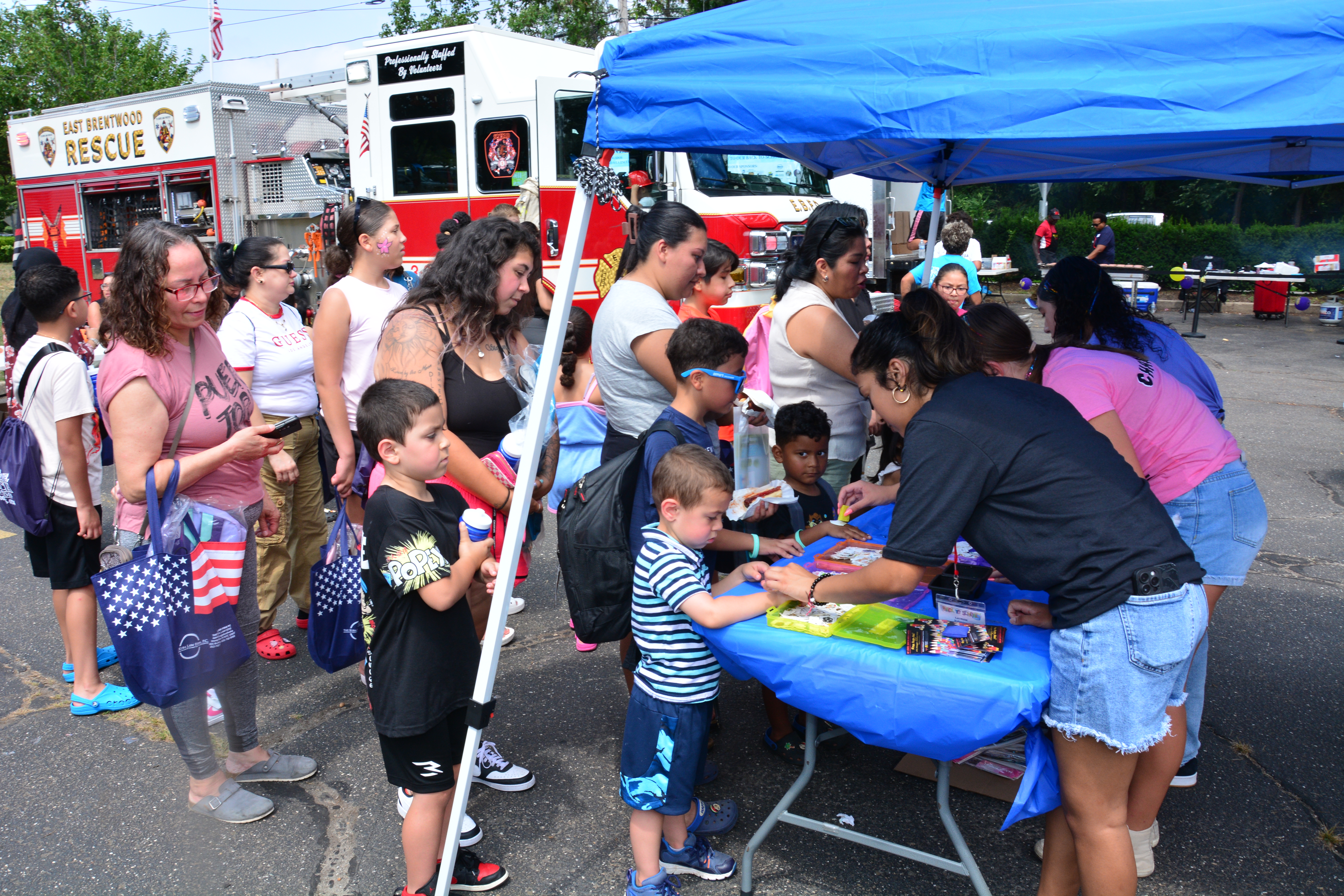 Children get temporary tattoos during Sen. Martinez's Brentwood backpack and school supply event on Saturday, Aug. 16, 2025.