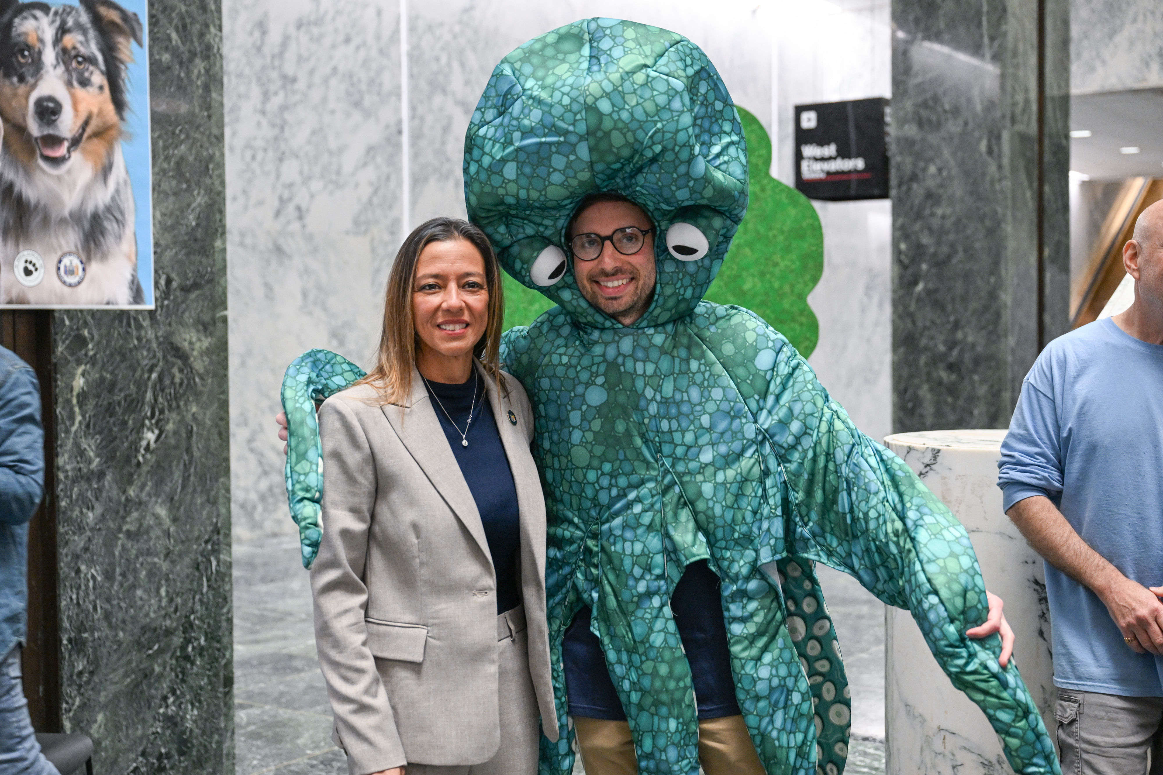 Senator Martinez stands next to a person wearing an octopus costume on Animal Advocacy Day.