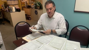 Senator Addabbo looks through the many constituent questionnaires that have come to his offices.