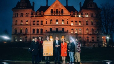 Senator Hoylman Sigal, AM Paulin, Advocates outside the capitol building, lit orange