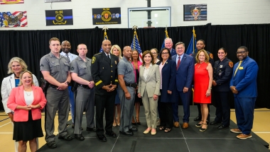 Photo - Attendees of GIVE Grant Announcement, including law enforcement officers and elected officials, stand for photo with governor in Brentwood. 