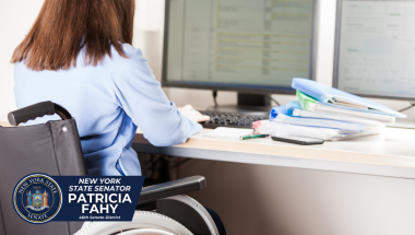 Employee living with a disability sitting at their desk in wheelchair
