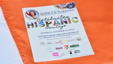 Image of a Hispanic Heritage Month Celebration Event Program placed onto a table at the event.