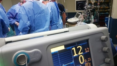 Photo image of hospital operating room with medical professionals at work
