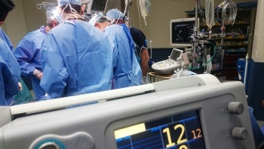 Photo image of hospital operating room with medical professionals at work.