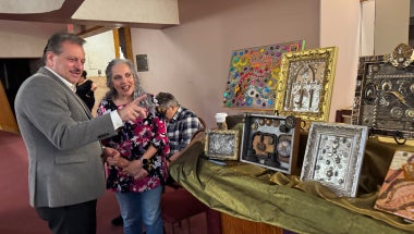 Senator Addabbo admires mixed media collages created by Amy Handy.
