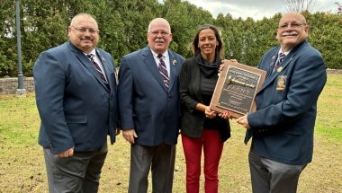 Photo of New York State Sen. Monica R. Martinez begin presented the Golden Trumpet Award by FASNY.