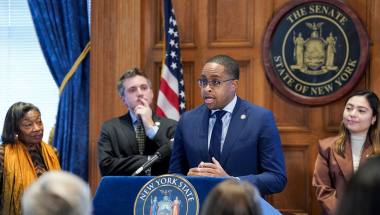 Senator Myrie at the podium discussing Esptein bill