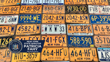Vintage NY license plates arranged on a table