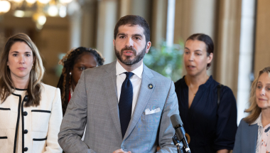 Senator Andrew Gounardes speaking at a press conference.