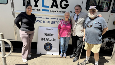 Senator Addabbo, center, is joined by Maria Barrientos, law graduate with NYLAG, left, and constituents Giuseppa Conti of Rego Park and Gary Wiegand of Middle Village outside the NYLAG van. 