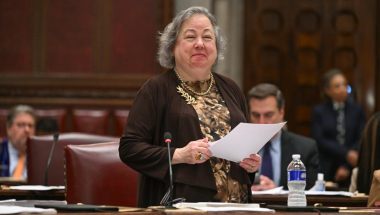 Senator Krueger smiles on the Senate floor during debate