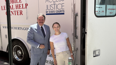 Senator Addabbo greets Kyle Koeppel Mann, an attorney with NYLAG.