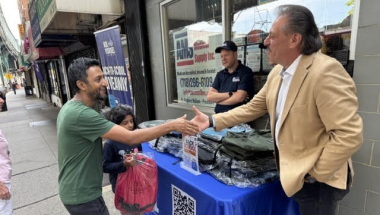 Senator Addabbo shakes hands with a constituent who was picking up school supplies.