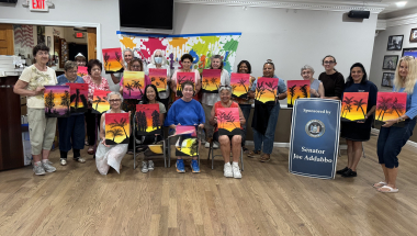 Everyone posed for a group photo displaying their art.