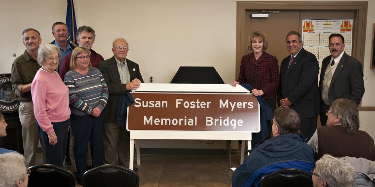 Family and friends of Susan Foster Myers join Senator Young, Assemblyman Giglio and local officials to unveil the sign for the Susan Foster Myers Memorial Bridge.