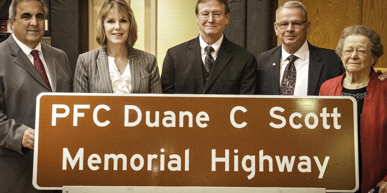 Assemblyman Joseph Giglio and Senator Catharine Young joined Steve and Tom Scott, two of PFC Duane Scott’s brothers, and PFC Scott’s mother, Patricia Scott, to dedicate State Route 275 as the “PFC Duane C Scott Memorial Highway.”