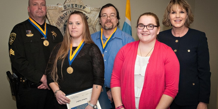 Sgt. Joseph Breu, Stephanie Stafford, Chester Gascon and Kaityln Walters were honored by Senator Young for their heroic actions during a house fire last March in Livonia.
