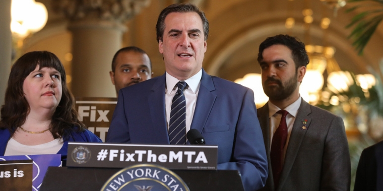 SENATOR GIANARIS SPEAKING AT A LECTERN DURING A FIX THE MTA PRESS CONFERENCE AT THE STATE CAPITOL