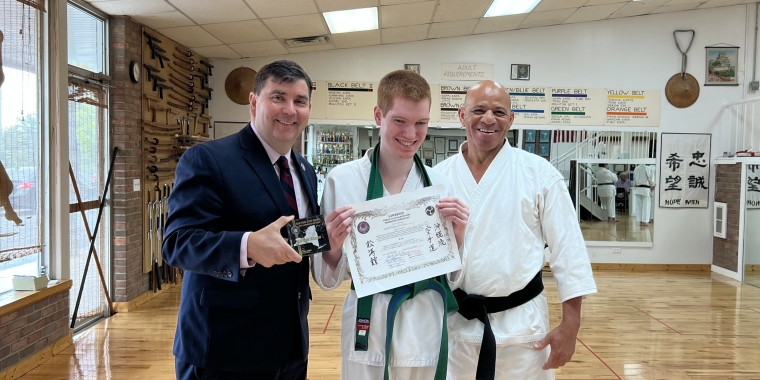 Senator John W. Mannion presents an official NYS Senate Commendation Award to Matthew Killian with Hanshi (Master) Rande Lawrence at Lawrence World Class Karate (LWCK) for winning two gold medals at the 2023 Niagara Karate Championship