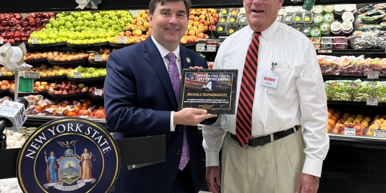 Senator Mannion presents NYS Senate Empire Award to Mike Hennigan, owner of Nichols Supermarket, in the store's produce section
