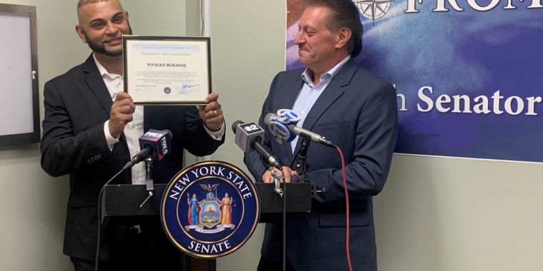 Senator Addabbo presents a citation to Pooran Mohabir