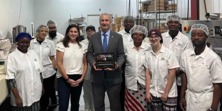 Senator Sean Ryan presents a New York State Senate Empire Award to the staff at Watson's Chocolates