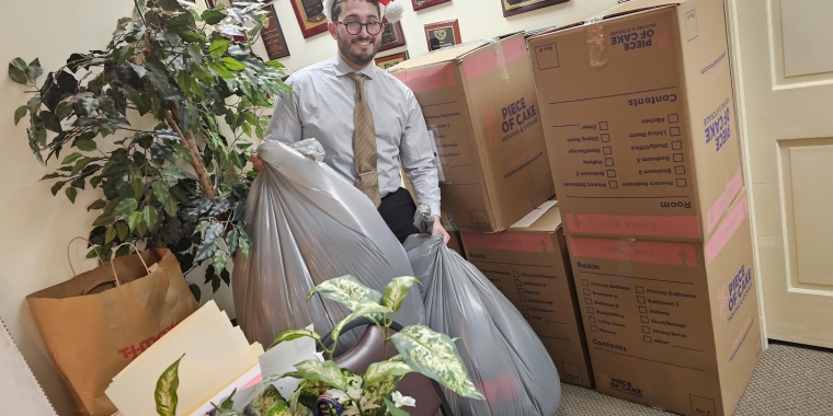 Addabbo's Chief of Staff, Raimondo Graziano, displays the coats collected at the senator's Woodhaven Office.