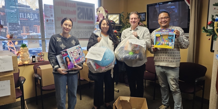 Resorts World Representatives collect toys to distribute to Jamaica Hospital.
