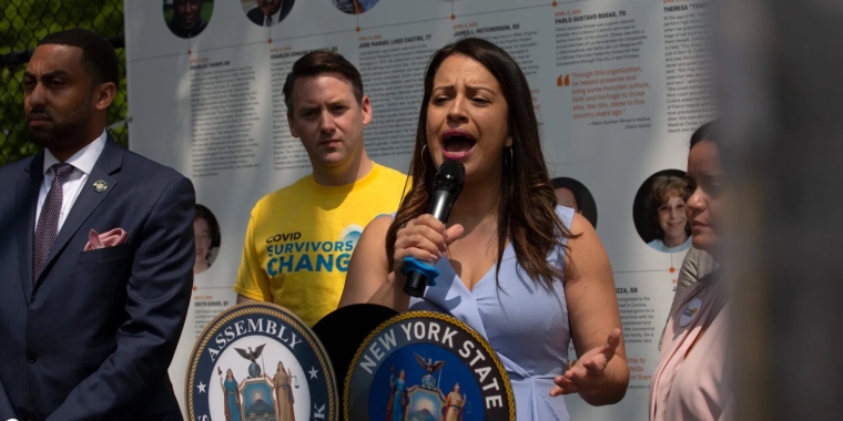 Woman speaking in front of Covid-19 memorial.