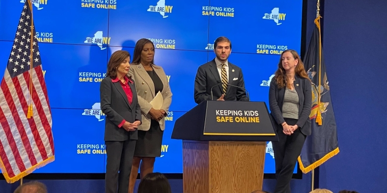Senato Andrew Gounardes stands alongside Attorney General Letitia James and Governor Kathy Hochul to push for protections for kids on social media.