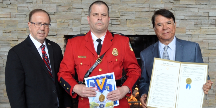 Sen. Joseph Griffo presents a New York State Senate Liberty Medal to OIN Police Officer Andrew Costello