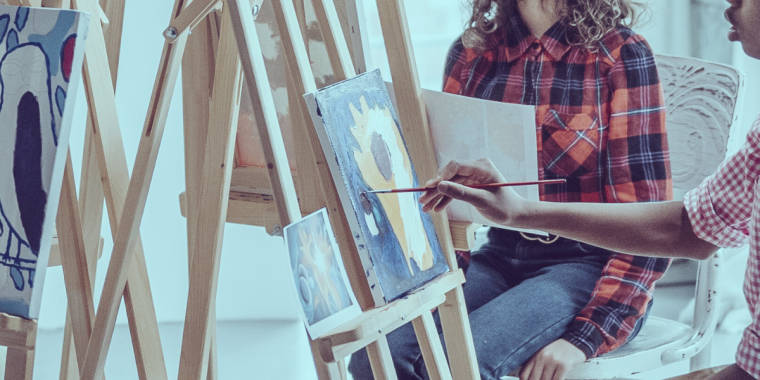 students painting on canvasses