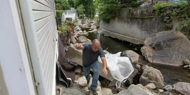 Brian Fredrickson talks about the damage caused by flooding on July 9, 2023, which washed away much of his backyard and now threatens the foundation of his family's house in Highland Falls. Allyse Pulliam / Special to the Times Union