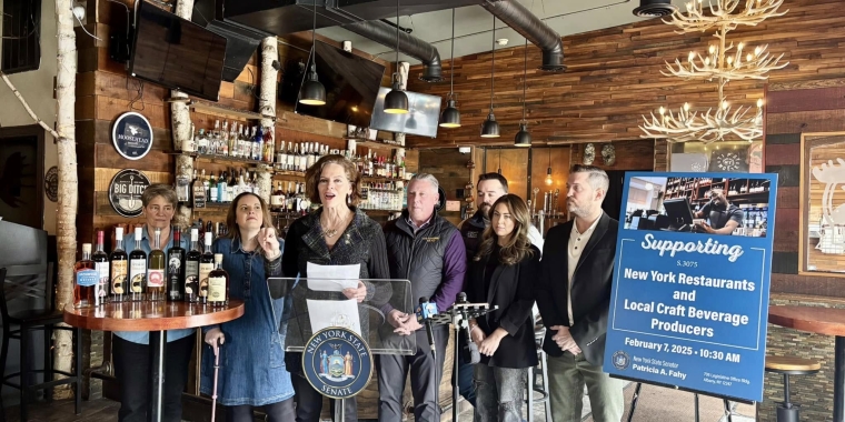 Sen. Fahy at the Tipsy Moose Tavern with business owner Rob Tario, and various elected officials.