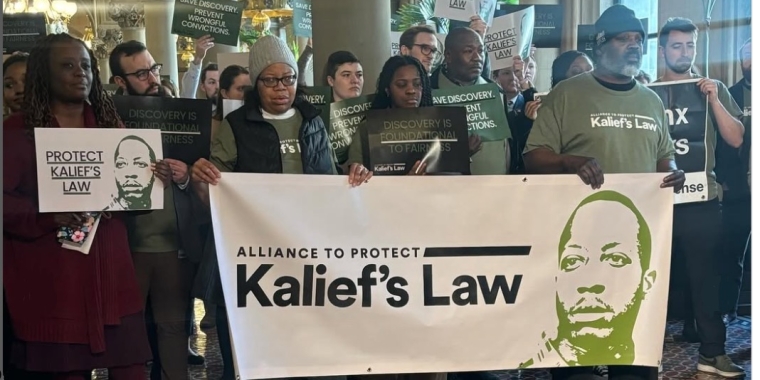 Source: Halimah Lawson Photo of Sen Cleare with actvisits and banner reading "Kalief's Law"