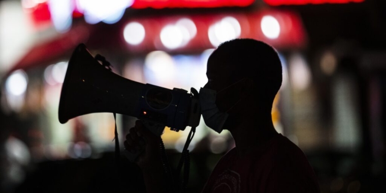 Myire_Trace_2025 A gun violence prevention worker addresses people gathered for an event in New York City’s Harlem neighborhood in 2020. New York is one of three states that established or expanded gun violence prevention offices this year. Frank Franklin II/AP Photo