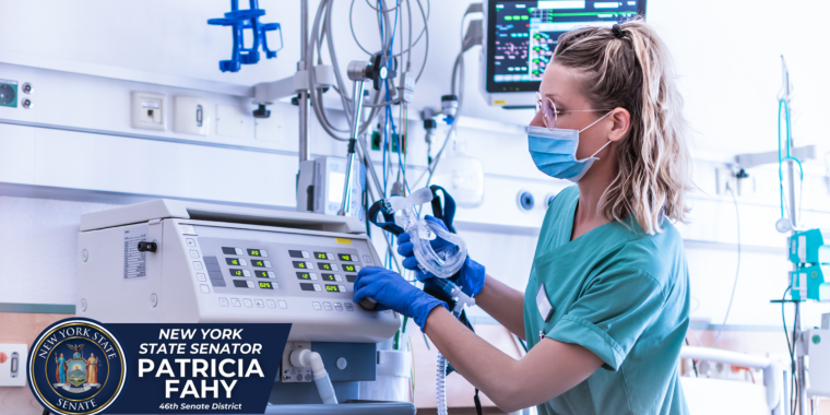 Healthcare worker with machines in hospital room