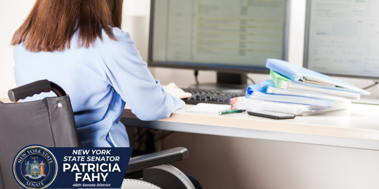 Employee living with a disability sitting at their desk in wheelchair
