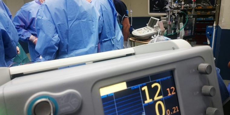 Photo image of hospital operating room with medical professionals at work