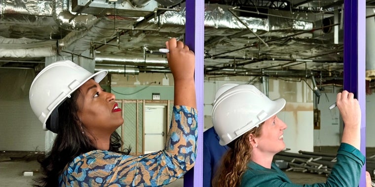 Senator Brouk signing steel beam