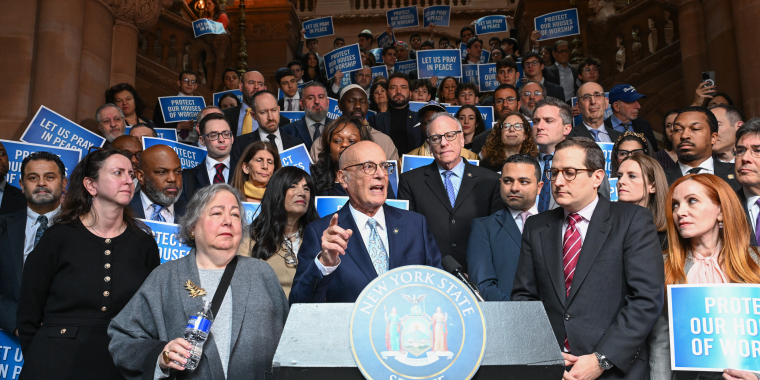 Senator Sutton speaking at a podium
