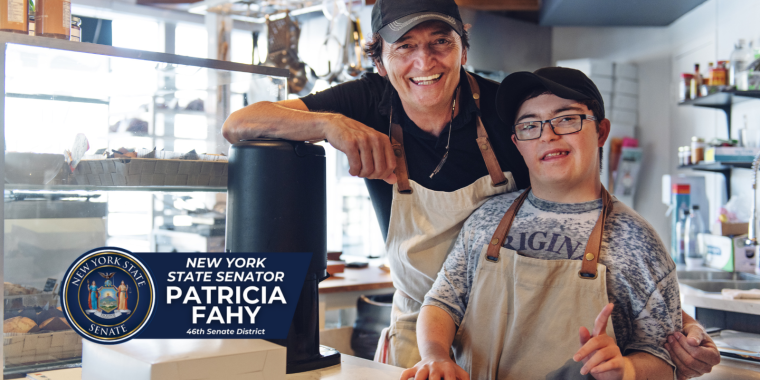 Employee with disabilities smiling with coworker at coffee shop/bakery