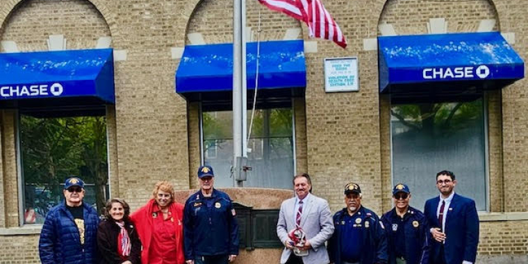 Senator Addabbo joins members of the American Legion Post 118 and Women's Auxillary to admire the newly flown flag.